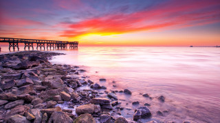 Sunset pier ocean rocks cityscape - a pier free wallpaper