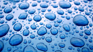 Water droplets blue surface macro 8 - a close up of water droplets free wallpaper