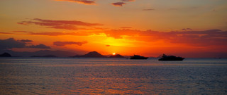Sunset boats mountain dusk ocean - a sunset free wallpaper