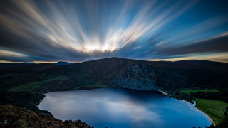 Lake mountains cloudy sky crepuscular - a mountain in the distance free wallpaper