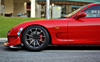 Red sports car parked building 3 - the side of the road in front free wallpaper