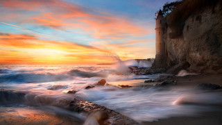 Sunset rocky beach lighthouse cliff - a sunset over a rocky beach free wallpaper