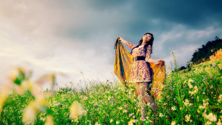 Woman field yellow scarf smile - a cloudy sky in the background free wallpaper