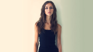 Eszter mattioni leesha hannigan arabesque - a black dress leaning against a wall free wallpaper