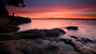 Fishing sunset lake shore rocks - rock and water free wallpaper