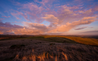 Cloudy sky hill grass dusk - a sky free wallpaper