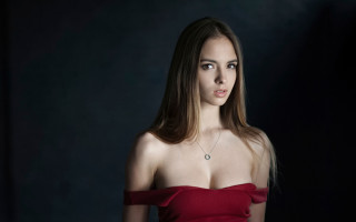 Woman red dress portrait dark - a black background behind her free wallpaper