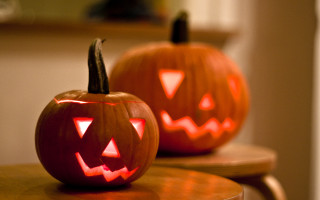 Carved pumpkins glowing faces spooky - orange free wallpaper