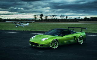 Green sports car runway plane - a plane in the background free wallpaper