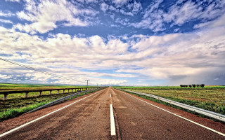 Cloudy sky road grass field - both side of it free wallpaper