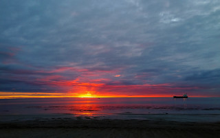 Sunset beach boat clouds ocean - a boat in the distance free wallpaper