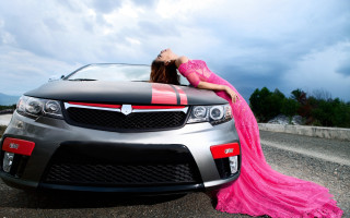 Woman pink dress leaning car - a cloudy sky in the background free wallpaper