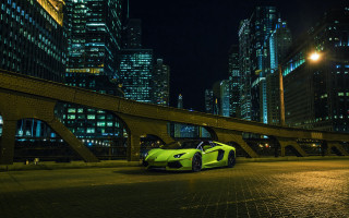 Yellow sports car city night - a city street free wallpaper