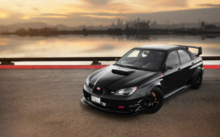Black car water city sunset - a black car free wallpaper