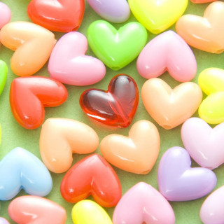 Heart shaped candies green surface - microscopic free wallpaper