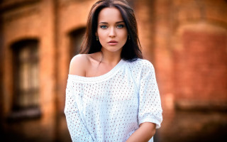 Woman white top brick wall 3 - a white top free wallpaper