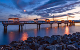 Pier lighthouse sunset rocks cloudy - sunset free wallpaper