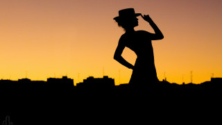 Woman dress hat sunset city - a city skyline in the background free wallpaper