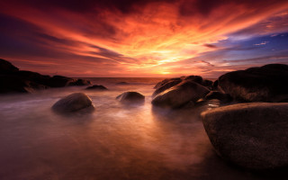 Sunset rocky beach cloudy sky 5 - a sunset over a rocky beach free wallpaper
