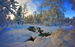 Snowy forest stream blue sky 2 - a matte painting free wallpaper
