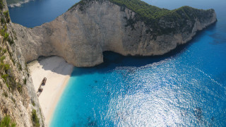 Beach boat rock cliff night - aerial free wallpaper