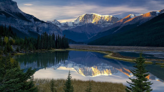 Mountain lake forest sunset waterfall - the foreground and a mountain range in the background free wallpaper