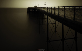 Foggy pier lighthouse horizon sunset - a lighthouse in the distance free wallpaper