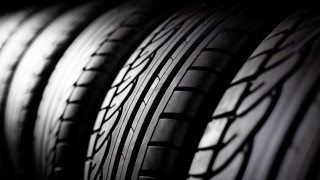 Tires lined up dark room - against a wall free wallpaper