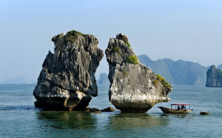 Boats rocks mountains ocean scenery - a couple of boats free wallpaper