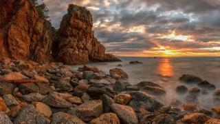 Rocky beach sunset surfboard mountains - a surfboard free wallpaper