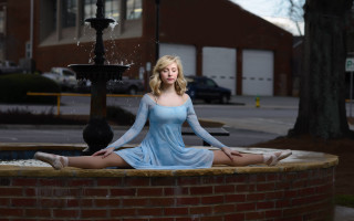Blonde woman blue dress sitting - front of a building free wallpaper