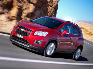 Red chevrolet suv mountain road - a rock formation in the background free wallpaper
