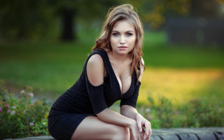 Woman black dress park sitting - her knee free wallpaper