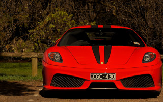 Red sports car parked wooden - a parking lot next free wallpaper