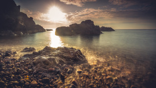 Rocky beach sunset ocean mountain - the shore free wallpaper