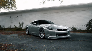 Silver sports car white building - andrew law free wallpaper