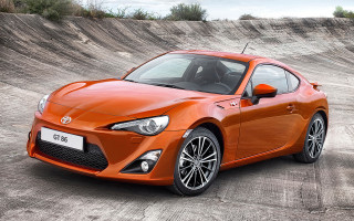 Bright orange sports car skateboard - a parking lot free wallpaper