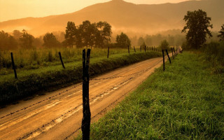Dirt road fence field sunset 2 - a fence and a field in the background free wallpaper
