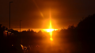 Bright sunset orange sky cityscape - crepuscular ray free wallpaper
