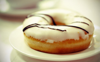 White plate frosted donut coffee - top of a table next free wallpaper
