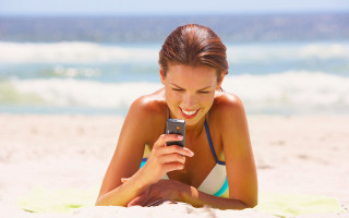 Beach woman smiling phone bikini - free bikini wallpaper