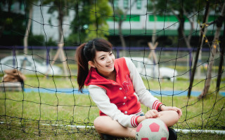Woman sitting soccer ball park - a soccer ball free wallpaper