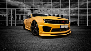Yellow sports car building cloudy - a cloudy sky in the background free wallpaper