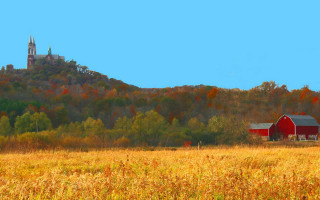Red barn fall autumn leaves - a church in the background free wallpaper
