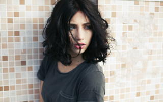 Woman blackshirt longhair bathroom tiledwall - a toothbrush free wallpaper