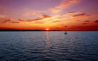 Sailboat sunset water mountain city - a sailboat free wallpaper