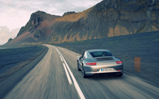 Silver car mountain road tilt 2 - a sky background and a mountain range in the distance free wallpaper