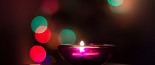 Lit candle bokeh macro glowing - top of a table next free wallpaper