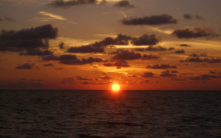 Sunset ocean clouds sailboat water - free sunset wallpaper