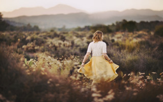 Woman yellow skirt flower field - the background in the distance free wallpaper